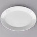 A white oval porcelain platter with a gray background.