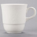 A white porcelain tea cup with a handle.