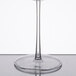 A clear Fineline plastic champagne flute with a stem on a reflective surface.