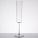 A Fineline clear plastic champagne flute with a long stem on a table.