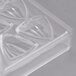 A clear plastic Matfer Bourgeat chocolate mold with triangular shapes.