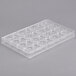 A clear plastic Matfer Bourgeat chocolate mold tray with triangular shapes.