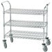 An Advance Tabco three-tiered metal utility cart with rubber casters.