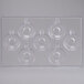 A clear plastic tray with 7 circle-shaped compartments and holes in it.