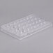 A clear plastic Matfer Bourgeat chocolate mold tray with 36 compartments.