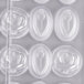 A close-up of a white Matfer Bourgeat polycarbonate chocolate mold with flowers in it.