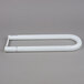 A Satco T12 white U-bend fluorescent light tube on a gray surface.