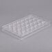 A clear plastic Matfer Bourgeat chocolate mold tray with half circle holes.
