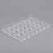A clear plastic Matfer Bourgeat chocolate mold with half round circles.