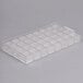 A clear plastic Chocolate World square mold tray with 32 squares.