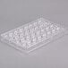 A clear plastic Matfer Bourgeat chocolate mold tray with half sphere-shaped holes.
