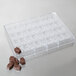 A plastic tray with 36 square chocolates.