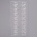 A clear plastic Chocolate World mold with 16 oval compartments.