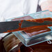 A chef uses a knife to cut a Matfer Bourgeat chocolate tablet