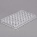A clear plastic Matfer Bourgeat chocolate mold tray with 40 diamond-shaped compartments.