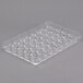 A clear plastic Matfer Bourgeat chocolate mold with many small diamond-shaped compartments.