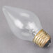 A clear Satco light bulb with a black base.