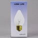 A Satco 60 watt clear shatterproof rough service light bulb in a package.