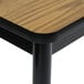 A medium oak Correll library table with a black base.