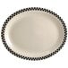 A white oval platter with a black and white checkered rim.
