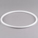 A white plastic gasket with a white circle.