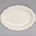 A white Homer Laughlin oval platter with scalloped edges.