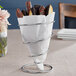 A Clipper Mill chrome spiral cone basket with chocolate covered cookies inside.