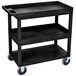 A black Luxor utility cart with three shelves and wheels.