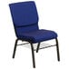 A navy blue church chair with a gold metal frame and book rack.