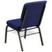 A navy blue church chair with a gold metal frame and dot patterned fabric.