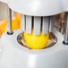 A Vollrath Wedgemaster II juicing a lemon.