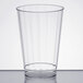 A clear plastic cup on a white surface.