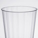 A close-up of a WNA Comet clear plastic fluted tumbler.