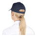 A woman with a ponytail wearing a navy blue 6-panel cap.