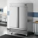 A stainless steel, double-door reach-in refrigerator on casters.