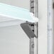 A metal shelf in a white Avantco GDS-47-HC merchandiser with LED lighting.