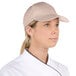 A chef wearing a white Choice Khaki 6-panel cap.