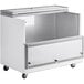 An Avantco stainless steel milk cooler on wheels.