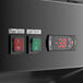 An Avantco black and white electronic control panel with a red rectangular switch and digital clock.