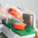 A person using a Garde tomato slicer to slice tomatoes.