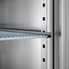 A stainless steel glass door reach-in refrigerator with adjustable shelving.