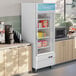 An Avantco glass door merchandiser freezer with LED lighting.