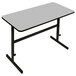 A gray rectangular table with black legs and a white frame.