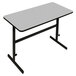 A white rectangular Correll standing height work station with a gray granite top and black frame.