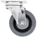 A metal swivel plate caster with a black rubber tire.