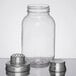 A clear glass Tablecraft Mason jar with a white lid and metal cap.