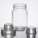 A Tablecraft glass mason jar with a metal shaker container and lid.