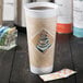 A close-up of a Dart Cafe G Espresso Foam Cup with a lid and a sticker on it.