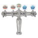 A Micro Matic chrome beer tap tower with 5 medallions above different colored beer labels.