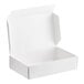 A white cardboard candy box with a white lid open.